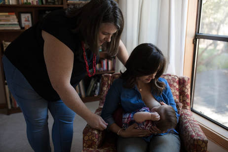 Tina Castellanos, IBCLC works with a mother and baby
